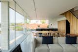 Living Room, Table, Chair, Stools, Sofa, Track Lighting, and Terrazzo Floor  Photo 5 of 12 in Cor-Ten Steel-Clad Prefab by Dwell from Explore a Prefabricated House For Sale in England That's Clad With Cor-Ten Steel