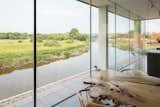 Perched along the banks of the River Ouse near the historic English town of Lewes is a Cor-Ten steel house with a