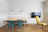 Dining Room, Table, Pendant Lighting, Medium Hardwood Floor, Chair, and Bench  Photo 2 of 13 in A Family Apartment in Prague That’s Filled With Clever Storage Solutions and Built-In Nooks