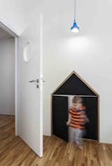 Kids Room, Medium Hardwood Floor, and Toddler Age  Photos from A Family Apartment in Prague That’s Filled With Clever Storage Solutions and Built-In Nooks