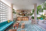 Inspired by Midcentury Miami architecture, this hotel located within a yoga retreat community center known as Holistika Tulum is a retro jungle oasis with cool custom-made floor tiles, rattan chairs and a calming aquamarine color scheme.  Photo 2 of 7 in 7 Modern Hotels in Mexico You Have to Visit
