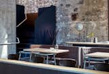This old power station in Melbourne was restored and transformed into a chic six-level restaurant. The raw brick and concrete structure of the original building was retained. The weathered look of the bricks walls serve as a dramatic backdrop to the fashionable, contemporary furniture that inhabits the space.  Photo 1 of 95 in favoritos by susana belo from 10 Modern Structures That Use Brick in Interesting Ways