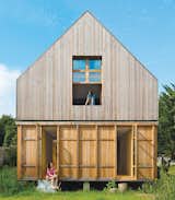 Designed by architecture firm Arba, this A-frame residence just 45-minutes outside of Paris has wood-stove heating, a solar vacuum tube for hot water, a washing machine, and a toilet that uses recycled water. Plus, it's connected to a 100-percent renewable grid that's supplied by French company Enercoop.