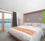 Bedroom, Floor Lighting, Concrete Floor, and Bed  Photo 1 of 362 in Vacation Home - Summer by Neiva Desrochers from Stay in a Modern Tin Cottage on Scotland’s Isle of Skye
