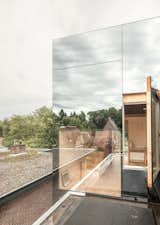 With an extension clad in mirrored glass that reflects the silhouettes of the existing brick house, "Mirror Mirror" is a home that shields its residents from view during the day, but exposes the extension's interiors at night.