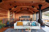 Living, Table, Sofa, Chair, Pendant, Coffee Tables, Ceiling, Hanging, and Dark Hardwood A traditional post-war-style old shack near a beach in Lorne, Victoria is remodelled with a top-level extension for better views of the ocean.  Living Table Hanging Sofa Photos from 11 Amazing Australian Homes