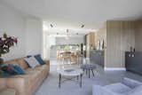 Living Room, Stools, Coffee Tables, Sofa, Chair, Ceiling Lighting, Pendant Lighting, and Rug Floor  Photo 6 of 17 in A Remodel Turns a Dark and Choppy House in Melbourne Into a Bright, Flexible Family Home