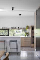 Kitchen, Wood Cabinet, Ceramic Tile Floor, Ceiling Lighting, and Wall Oven  Photo 7 of 17 in A Remodel Turns a Dark and Choppy House in Melbourne Into a Bright, Flexible Family Home