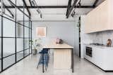 Kitchen, Marble, Wood, Concrete, Track, Wall Oven, Range, Drop In, and Marble  Kitchen Marble Wall Oven Wood Track Photos from An Art Deco Warehouse in Melbourne Is Converted Into a Shared Office Space