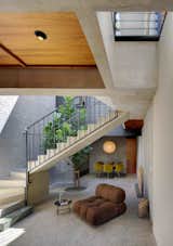Chair, End Tables, Skylight, Metal, Staircase, Metal, and Concrete  Staircase Skylight Photos from Find Out How Light and Precious Outdoor Space Were Introduced to an Old Australian Cottage