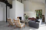 Living Room, Chair, Sofa, Floor Lighting, Standard Layout Fireplace, and Coffee Tables  Photo 4 of 14 in An Abandoned Stable in Spain Is Transformed Into a Sustainable Vacation Home For Rent