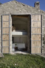 Exterior, Barn, Wood, Stone, Farmhouse, and House  Exterior Wood House Barn Photos from An Abandoned Stable in Spain Is Transformed Into a Sustainable Vacation Home For Rent
