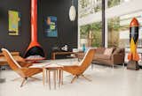 Soft earthy browns can bring a masculine feel to living rooms and studies. Choose wood verneers, furniture or woven textiles in earthy browns to give spaces a grounded feel. For midcentury brown paint colors, try Behr's Cocoa Shell HDC-AC-05 or Wright Oak Bark FLLW623.  Photo 1 of 8 in 7 Paint Colors That Nail the Midcentury-Modern Look from Favorites