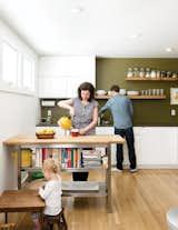 Kitchen, White, Ceiling, Drop In, Open, Light Hardwood, and Wood Custom floating shelves and a book shelf under a movable island counter cleans a fuss-free, streamlined look in this kitchen.  Kitchen Open Drop In Light Hardwood Photos from 4 Decluttering Tips From Organizing Master Marie Kondo