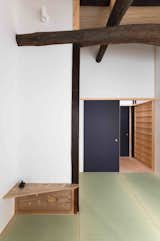 On the upper level is a bathroom, a bedroom with western-style beds and a dressing area, and a second bedroom with tatami floors and Japanese-style futon beds.