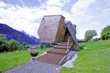 Designed by architects Peter and Lukas Jungmann, this holiday cabin near an old farmhouse in the East Tyrolean village of Nussdorf, Austria, is covered in rustic Austrian-style shingles. Its sharp angles and asymmetrical shape gives it a distinctly futuristic, UFO-like appearance.&nbsp;
