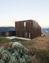 Openess and isolation is what architect Jesse Garlick’s enjoys most about his rural off-the-grid, prefabricated vacation home in the eastern Washington desert. The house has a steel façade that mimics the ochre-red bedrock in the area.  Photo 6 of 8 in 7 Prefabs Set in Nature