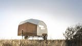 Built with modernist industrial techniques, this tiny, 44-square-foot, teardrop-shaped hybrid prefab trailer has a boat-like shell that was built with a lightweight frame enclosed with taut fabric and sheets of Jobert Okume marine plywood.