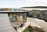 On a rocky outcrop in the Norwegian town of Larvik in Vestfold County, Oslo-based firm Lund Hagem Architects renovated an 807-square-foot summer cabin with generous patios that take advantage of dramatic coastal views.