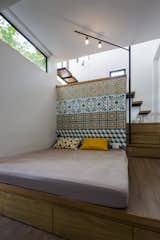 Bedroom, Bed, Floor Lighting, and Medium Hardwood Floor  Photo 5 of 19 in See How This Compact Home in Vietnam Makes the Most of 194 Square Feet