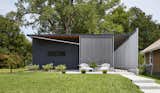 Exterior, Flat RoofLine, House Building Type, and Metal Siding Material Using insulted metal panels that were rejected from the construction of a tennis center nearby, this sustainable home in Kansas by Studio 804 was inspired by the prefab Lustron houses that were developed in the United States after World War II.  Photos from 9 Best Homes With Interesting Screened Facades