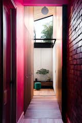 Home to architect Michael Artemenko, co-director of FIGR Architecture Studio—along with his wife Emma and their young daughter—this renovated heritage home in the Melbourne suburb of Cremorne uses a portal-like corridor painted a vibrant pink to connect the original period home to a new wing.