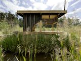 Named after its charred-larch cladding, this tearoom designed by Czech studio A1 Architects sits next to a lake in a wooded area near Česká Lípa, Czech Republic. Its sliding doors can be opened for enhanced connectivity with the surrounding nature, or closed to create a more secluded oasis. At the center of the space is a hearth that has a teapot suspended from the sisal rope-domed ceiling above it.