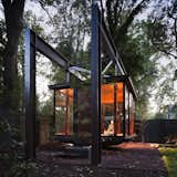 Shed & Studio Suspended in a garden in private residence in the northwest of Washington DC, this bronze and glass building, which is illuminated from the ground up, looks like a Japanese tea pavilion, but is in fact a musical recital space that its owner also use as a room for dining and contemplation.  Photos from 6 Tiny Outdoor Pavilions Inspired by Japanese Tearooms