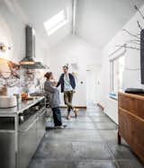 Passionate about recycling, a Belgium designer couple Michaël Verheyden and Saartje Vereecke upcycled a beautifully veined marble tabletop from Vereecke’s parents’ house as the backsplash for their kitchen, pairing it with metal countertops for a chic industrial look.