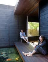 Outdoor and Wood Patio, Porch, Deck Designed by architect Sebastian Mariscal, the Wabi House in Southern Californian houses serenity inspiring features like a koi pint within its Shou Sugi Ban walls.  Photo 20 of 22 in 17 Shou Sugi Ban Homes That Are Singed to Perfection