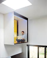 When architect Marc-André Plasse realized that he was unable to add a second story to his Montreal house due to a weak foundation, he squeezed out another 500 square feet with a clever multilevel addition on one side to create a master bedroom with an interior-facing balcony that cantilevers over the dining area.