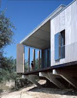 Designed by Italian architect Maria Giuseppina Grasso Cannizzo, this holiday villa in the Sicilian countryside is intelligently designed so it’s raw wood board louvres can be opened to create a balcony that looks out to the countryside and sea beyond, or closed to maximize interior space.