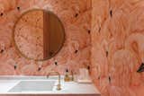 Bath Room, Marble Counter, and Drop In Sink This Singapore apartment, renovated by Takenouchi Webb, features a guest bathroom covered in eye-popping flamingo-print wallpaper.  Photo 12 of 14 in 7 Wallpaper Designs That Will Instantly Revamp Your Space from 8 Bold Bathrooms That Don't Back Away From Color