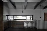 Kitchen, Range, Wood Cabinet, Pendant Lighting, Drop In Sink, and Dark Hardwood Floor  Photo 8 of 13 in One of Melbourne's Oldest Prefab Timber Cottages Gets a Second Chance