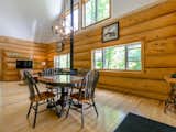 Dining Room, Chair, Table, Pendant Lighting, Wood Burning Fireplace, and Light Hardwood Floor  Photos from 8 Outstanding Cabins For Rent in Canada