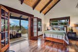 Bedroom, Dark Hardwood Floor, Table Lighting, Lamps, Night Stands, and Bed  Photo 10 of 10 in 9 Vacation Rentals That Will Make You Want to Book a Flight to Hawaii