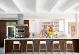 Kitchen, Refrigerator, Marble Counter, Wall Oven, Range Hood, Track Lighting, Range, Ceiling Lighting, and Wood Cabinet  Photo 3 of 7 in 7 Design Tips For a Chef-Worthy Kitchen