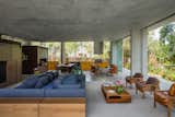 Living Room, Chair, Coffee Tables, Sofa, and Concrete Floor  Photo 8 of 13 in A Concrete Home in Brazil Lets the Owners Practically Live in the Jungle