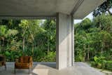 Outdoor, Trees, Shrubs, Walkways, Concrete Patio, Porch, Deck, and Hardscapes  Photo 3 of 13 in A Concrete Home in Brazil Lets the Owners Practically Live in the Jungle