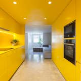 Designed by London-based practice Russian For Fish, this remodeled Victorian features a nearly all-yellow kitchen, with a monochromatic scheme that extends across the cabinetry and ceiling.