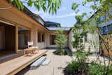 Outdoor, Garden, Small Patio, Porch, Deck, Trees, Hardscapes, Vertical Fences, Wall, Back Yard, and Gardens  Photo 11 of 14 in A Super-Insulated Home in Japan Brings Comfort to an Elderly Couple