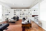 Living, Sofa, Coffee Tables, Chair, Medium Hardwood, Rug, Shelves, Ceiling, and Ottomans  Living Ottomans Shelves Medium Hardwood Rug Photos from This Renovated Pad in São Paulo's Iconic Lausanne Building Is a Breath of Fresh Air