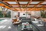 Living, Rug, Chair, Sectional, Ottomans, Concrete, End Tables, Coffee Tables, Floor, and Table  Living Table Ottomans Sectional Rug Photos from This Brilliant Brazilian Abode Was Designed Around an Imposing Tree