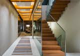 Staircase, Glass Railing, Metal Railing, and Wood Tread  Photos from This Brilliant Brazilian Abode Was Designed Around an Imposing Tree