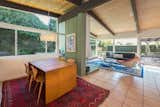 Dining, Table, Rug, Ceiling, Chair, Pendant, and Terra-cotta Tile  Dining Terra-cotta Tile Pendant Ceiling Photos from An Immaculate Midcentury Abode in San Diego Asks $1.55M