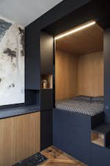 The cube is connected to a kitchenette with built-in cabinetry.
