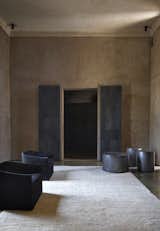 Living Room, Ceiling Lighting, Chair, Concrete Floor, End Tables, and Rug Floor Interiors of Villa D.  Photo 3 of 10 in 4 Enchanting Moroccan Villas by French Duo Studio KO