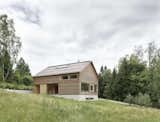 Innauer Matt Architekten designed the house as simple wooden building resting atop a solid, reinforced concrete plinth.