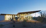 This house in Arizona’s Sonoran Desert has concrete walls and floors and covered quartzite stone decks facing both the east and west.
