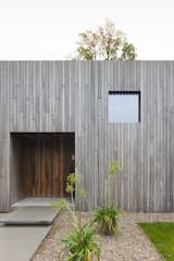 Exterior, Wood Siding Material, House Building Type, and Flat RoofLine Like the windows, the front door is also a square.  Photos from A Belgian Architect’s Courtyard House Offers Work/Life Balance